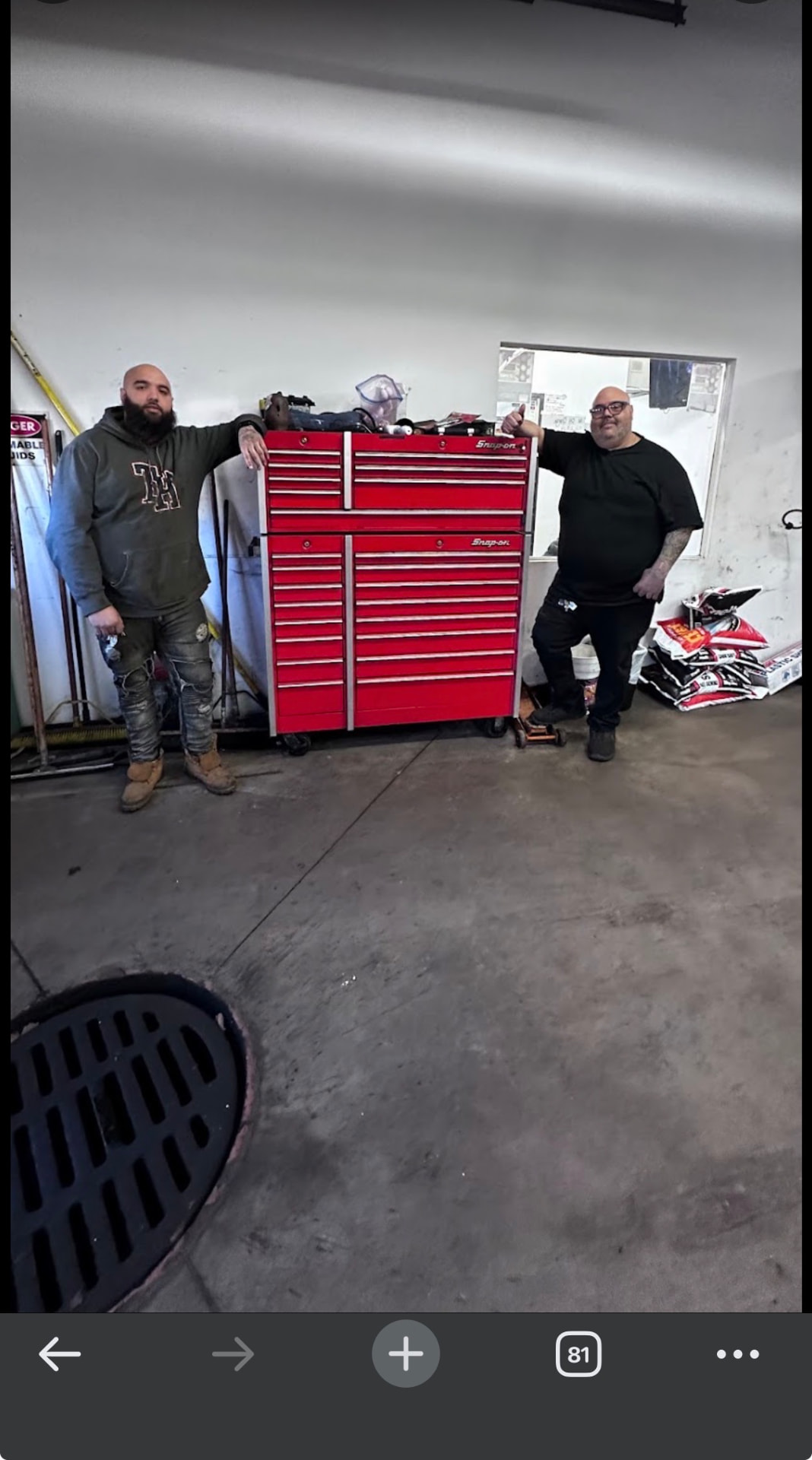 Sam's Auto by CUBI technicians beside a red Snap-on tool chest